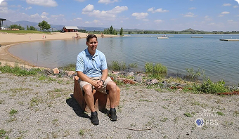 Jason Dennen being interviewed with a lake in the background