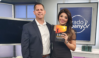 Jason Dennen with a woman holding his book