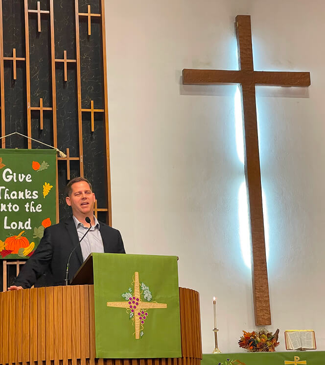 Jason speaking in church podium